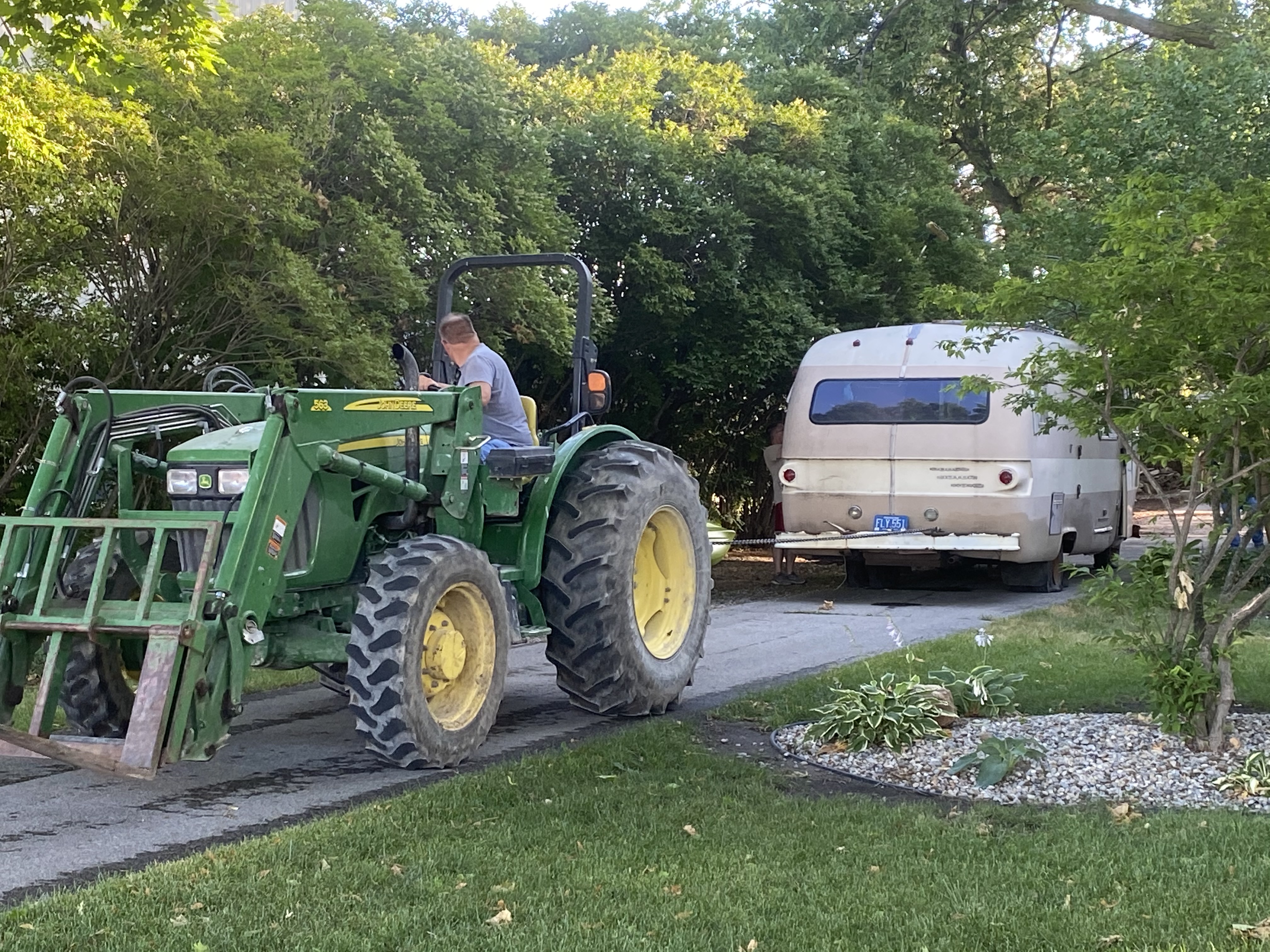 Guy on tractor pulling motorhome