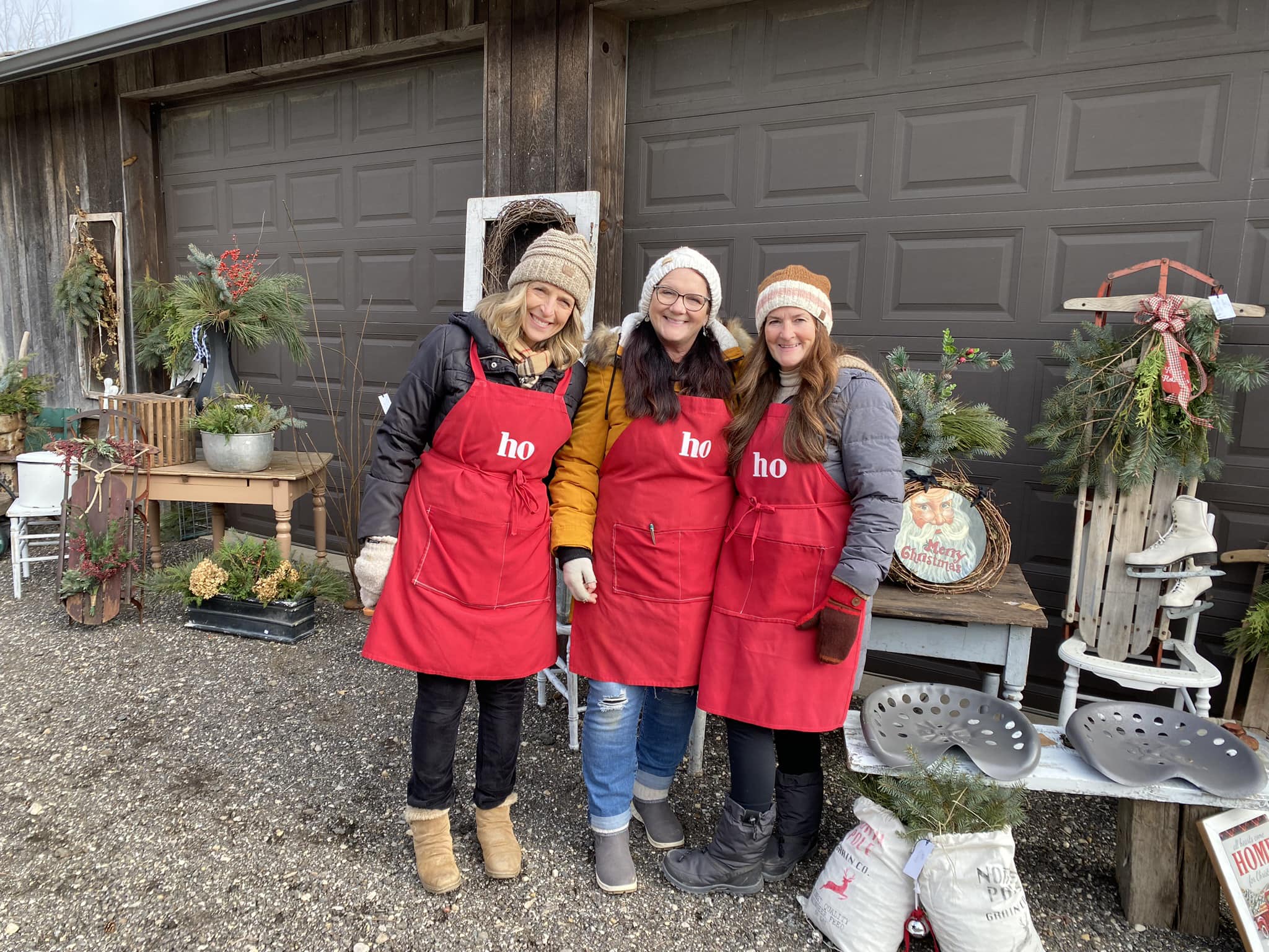 Three women in red working during a barn sale