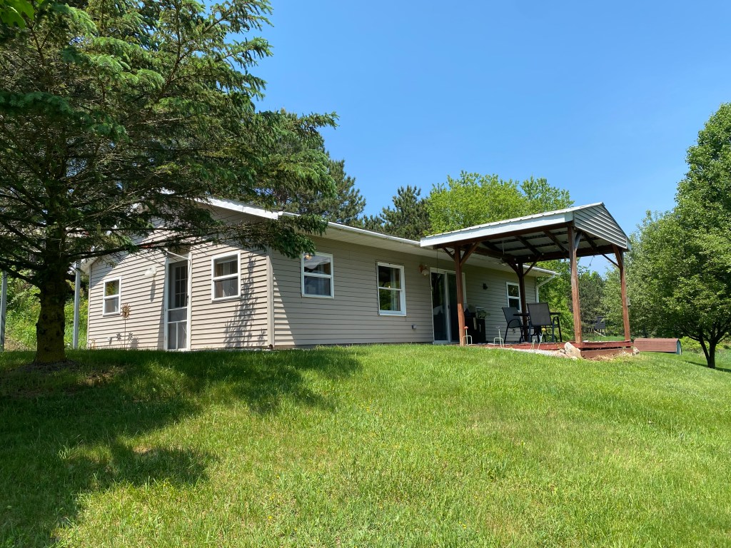 Small home with tan siding